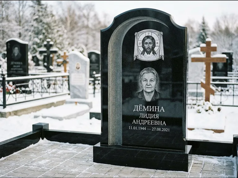 Памятник с гравировкой иконы: гранёный восьмиугольный обелиск с крестом — гравировка Николая Чудотворца, семейный участок с гранитной скамьёй, работа «Зотов» в Нижневартовске