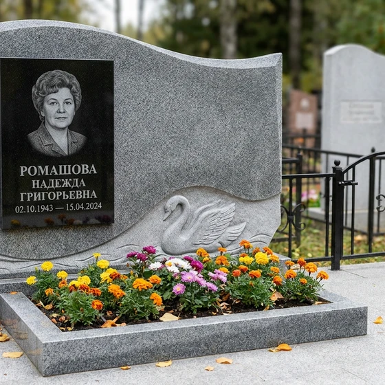 Памятник с лебедем из мансуровского гранита с волнообразной стелой